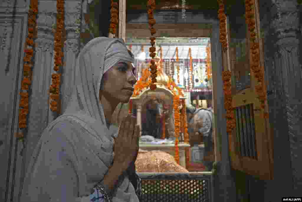 A Sikh pilgrim offers prayers at a gurdwara in Lahore, Pakistan, on June 16.