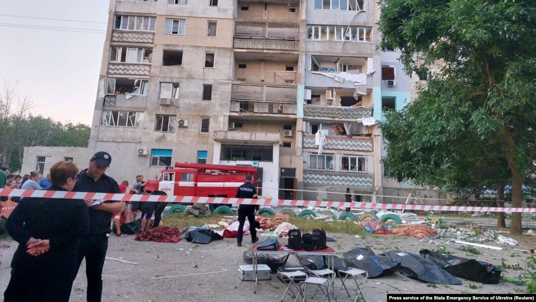 Body bags containing the remains of some of the 21 civilians killed by a Russian missile strike lie in front of a damaged residential building in the village of Serhiyivka on July 1.
