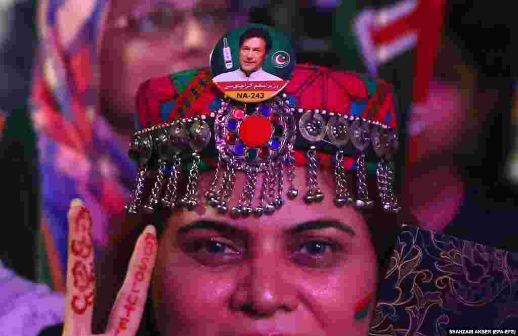 Supporters of opposition party Pakistan Tehrik-e Insaf listen to party leader and former Prime Minister Imran Khan during a protest in Karachi on June 19.