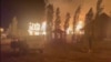 Fires blaze at a recreational center on Lake Alakol. The expansion of human activity toward forested areas, such as spa resorts and dachas, endangers Kazakhstan's limited forest land and the biodiversity that accompanies it.