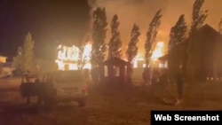 Fires blaze at a recreational center on Lake Alakol. The expansion of human activity toward forested areas, such as spa resorts and dachas, endangers Kazakhstan's limited forest land and the biodiversity that accompanies it.