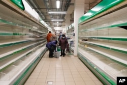 People buy the last remaining groceries at a Finnish Prisma store after the Finnish holding company S-Group decided to curtail all operations in Russia following Moscow's invasion of Ukraine. Russians cut their spending last year at the fastest pace since 2015 as the war took its toll on consumer confidence.