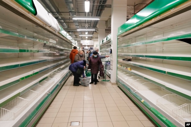 People buy the last remaining groceries at a Finnish Prisma store after the Finnish holding company S-Group decided to curtail all operations in Russia following Moscow's invasion of Ukraine. Russians cut their spending last year at the fastest pace since 2015 as the war took its toll on consumer confidence.