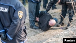 Bosnian police detain an antigovernment protester in Tuzla on February 6. 