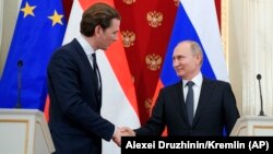 Russian President Vladimir Putin (right) and Austrian Chancellor Sebastian Kurz shake hands after a joint news conference following their talks in Moscow in February.