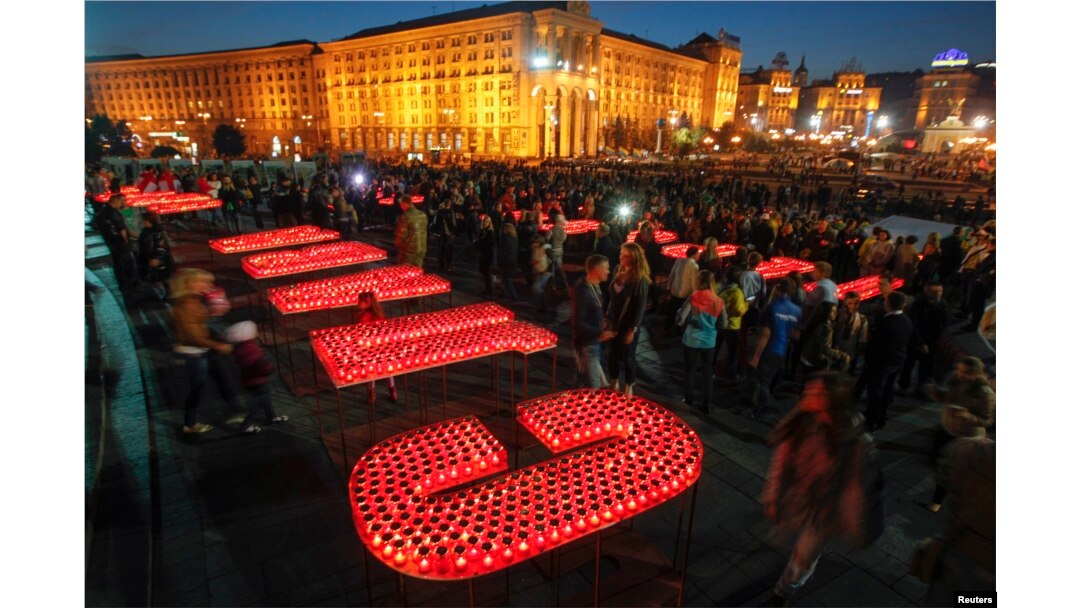 People light candles at Independence Square in Kyiv to form the words "Glory to Ukraine, glory to the Heroes!" during a rally to show support for servicemen on the front line in eastern Ukraine in 2014.