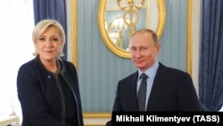 Marine Le Pen, leader of the far-right French National Rally party, meets with Russian President Vladimir Putin in Moscow in March 2017. 