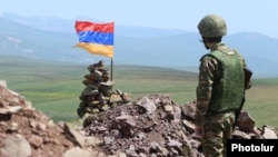 An Armenian soldier stands watch on the frontier.