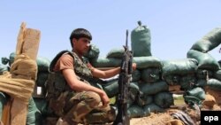 Afghanistan -- A member of the Afghan security forces takes up a position during an operation against Taliban fighters in Nad Ali district of Helmand province, April 27, 2016