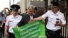 Sergei Mitrokhin (center), head of the Moscow Branch of the liberal opposition Yabloko Party, is detained by police outside the State Duma during a protest against planned pension reform. 