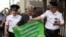 Sergei Mitrokhin (center), head of the Moscow Branch of the liberal opposition Yabloko Party, is detained by police outside the State Duma during a protest against planned pension reform. 
