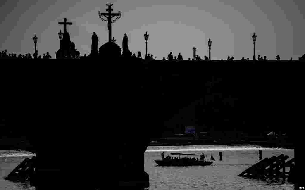 A small boat is pictured under the medieval Charles Bridge in central Prague, Czech Republic. (epa/Filip Singer)