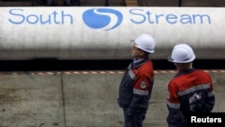 Workers stand near pipes made for the South Stream pipeline at the OMK metal works in Vyksa in Russia's Nizhny Novgorod region.