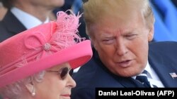 U.S. President Donald Trump (R) talks to British Queen Elizabeth II during an event to commemorate the 75th anniversary of the D-Day landings, in Portsmouth, southern England, June 5, 2019