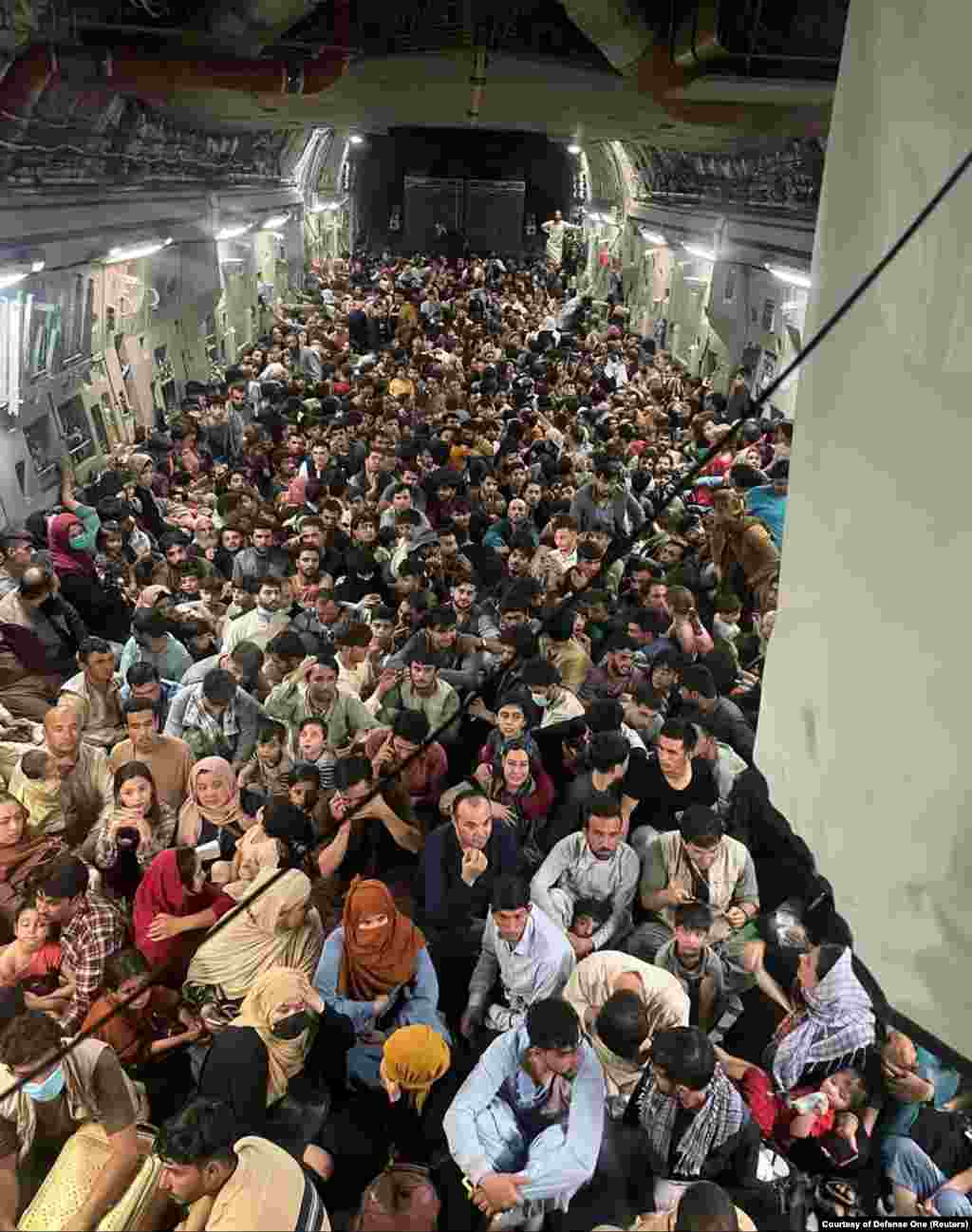 Evacuees crowd the interior of a U.S. Air Force C-17 Globemaster transport aircraft. It carried some 640 Afghans to Qatar from Kabul on August 15.