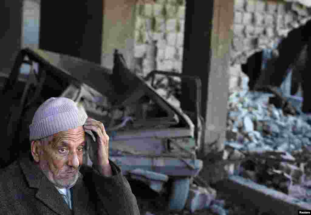 A Palestinian man sits inside a damaged house after Israeli air strikes in Gaza City. Israel exchanged the fiercest fire with Hamas in years after assassinating its military mastermind and threatening a wider offensive in the Gaza Strip to stem Palestinian rocket salvoes. (Reuters/Suhaib Salem)