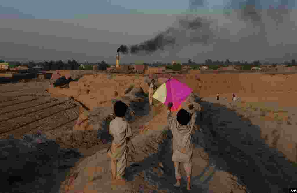 Afghan children fly a kite on the outskirts of Jalalabad. (AFP/Noorullah Shirzada)