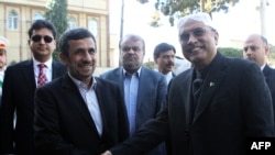 Iranian President Mahmud Ahmadinejad (left) shakes hands with Pakistani President Asif Ali Zardari upon his arrival for a meeting in Tehran on February 27.