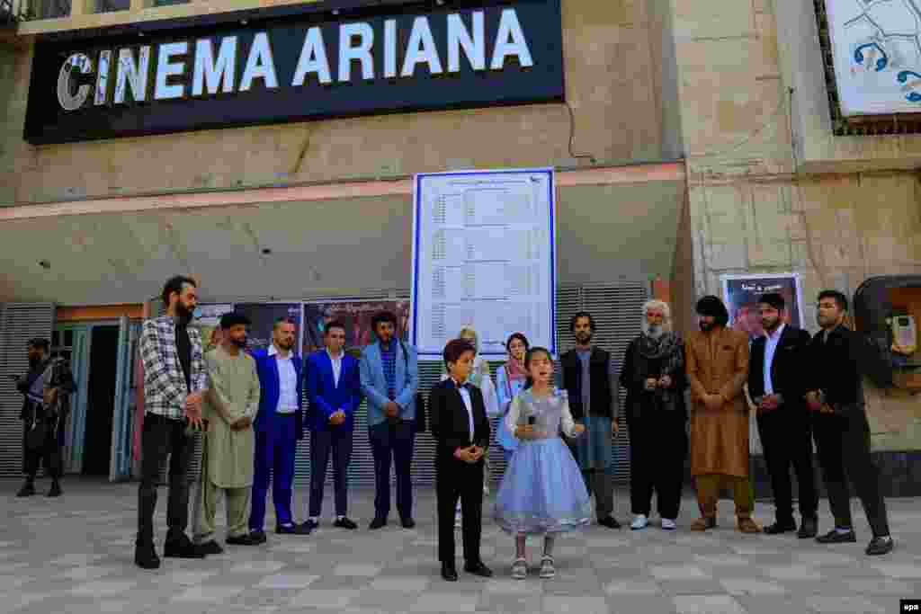 Cast and crew of the short film Mardab Lala gather outside the Ariana Cinema on August 29, 2022, the date of the theater's reopening following the Taliban takeover in Afghanistan.