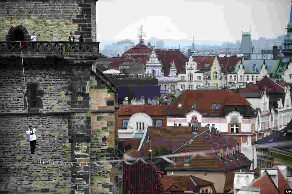 A tightrope walker balances on a rope over Old Town Square in Prague as part a campaign in support of people with diabetes. (AFP/Michal Cizek)