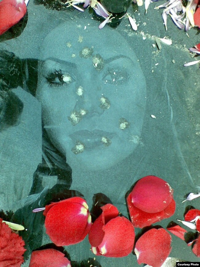 The bullet-riddled gravestone of Neda Aqa Soltan, a young protester whose death during anti-government demonstrations in 2009 sparked international outrage. (file photo)