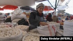 A woman sells dried curds at the central market in Bishkek, back to normal after April's violence.
