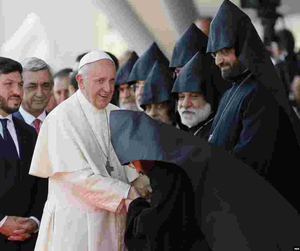 Armenia --  Pope Francis (C) greets Armenian priests during the official welcoming ceremony at the Zvatnots International airport, Yerevan, June 24, 2016