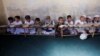 Afghan boys read the Koran at a madrasah in Kabul.