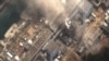 Japan - The No.3 nuclear reactor of the Fukushima Daiichi nuclear plant at Minamisoma is seen burning after a blast following an earthquake and tsunami in this handout satellite image taken 14Mar2011