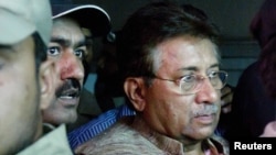 Pervez Musharraf is escorted by security officials as he leaves an antiterrorism court in Islamabad on April 20.