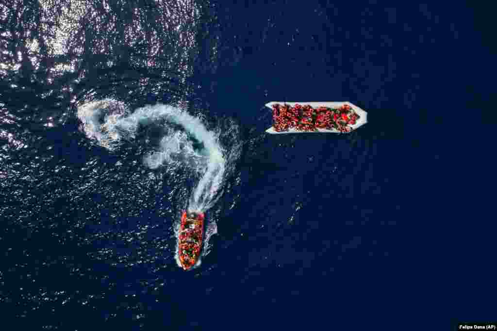 Refugees and migrants are rescued by members of the Spanish NGO Proactiva Open Arms group after leaving Libya as they were trying to reach European soil aboard an overcrowded rubber boat, north of the Libyan coast. In total, 105 refugees and migrants from Bangladesh, Egypt, Nigeria, Morocco, Ghana, Pakistan, Sudan, Libya, Eritrea, and Senegal were rescued. (AP/Felipe Dana)