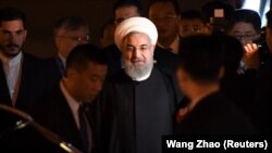CHINA -- Iranian President Hassan Rohani walks to his car after walking out from the airplane upon his arrival at Qingdao Liuting International Airport, Shandong province, June 8, 2018
