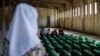 Coffins containing the remains of 71 people killed in Srebrenica are discharged from a former battery factory&nbsp;at the&nbsp;Potocari Memorial Center, on July 10, ahead of burial the next day.