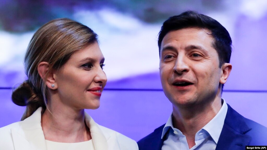 Volodymyr Zelenskiy, and his wife, Olena, greet supporters at his headquarters after the presidential election in Kyiv on April 21.