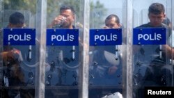 Police guard the entrance of Gezi Park on Taksim Square in Istanbul on June 17. 