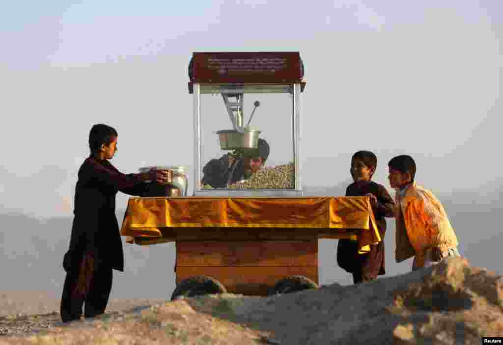 Children buy popcorn in Kabul on October 31. (Reuters/Mohammad Ismail)