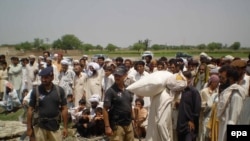 Displaced persons from South Waziristan receive rations in Pakistan's hard-hit Northwest Frontier Province