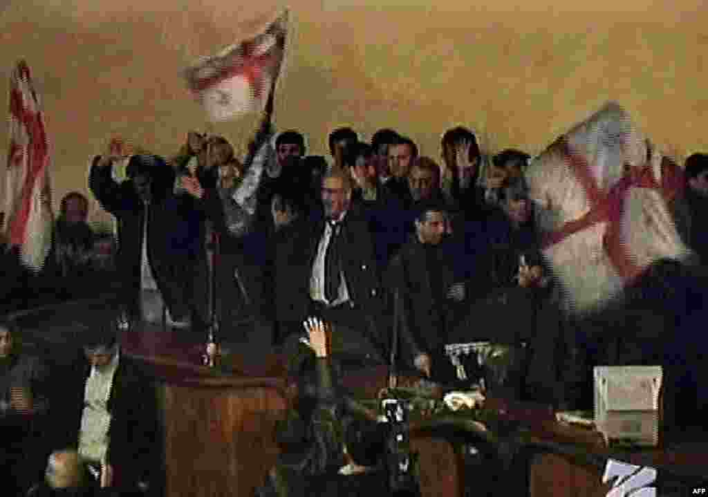 Georgian television shows opposition protesters waving flags inside the parliament on November 22.