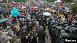 Riot police detain demonstrators during an anticorruption protest in St. Petersburg on June 12.