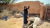 Woman drawing water from a well in Gheizanieh, Khuzestan. Undated photo. 