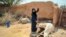 Woman drawing water from a well in Gheizanieh, Khuzestan. Undated photo. 
