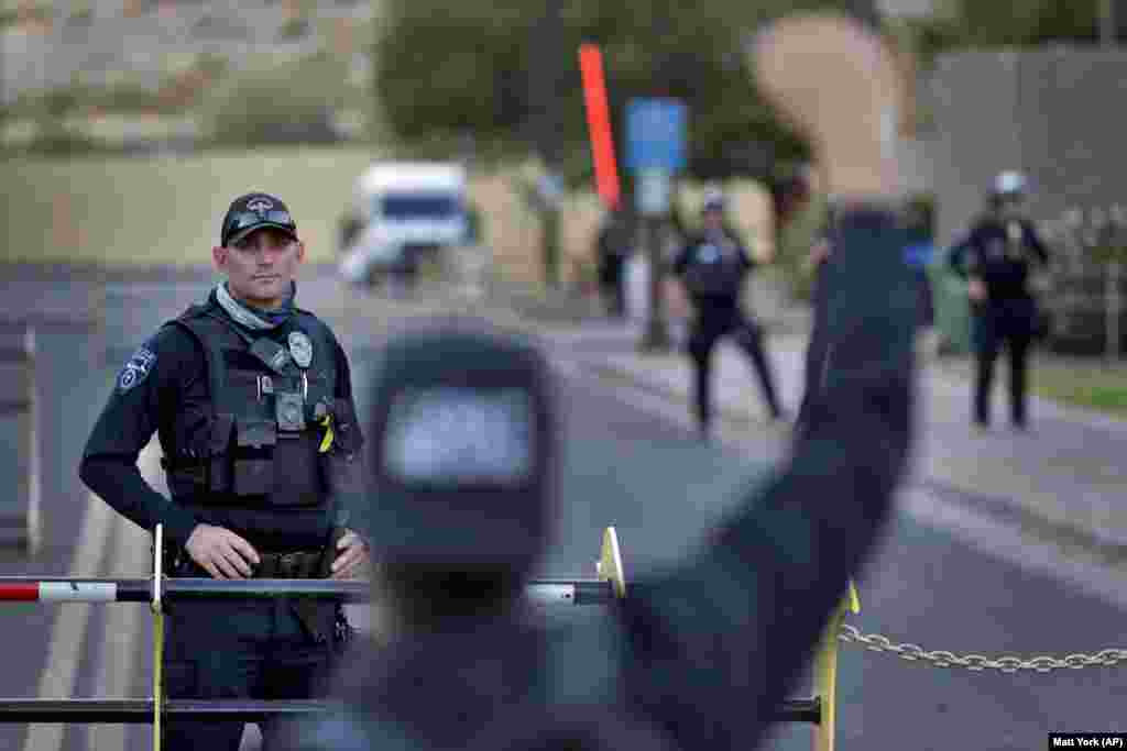 A protester confronts a Tempe police officer during a rally, Thursday, June 11, 2020, in Tempe, Ariz. Protesters were demanding reallocation of Tempe Police Department funding to community programs. The protest stems from the death of George Floyd, a black man who died after being restrained by Minneapolis police officers in May.