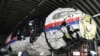 Lawyers inspect the reconstructed shell of Malaysia Airlines Flight 17 at the Gilze-Rijen Air Base in the Netherlands on May 26.&nbsp;