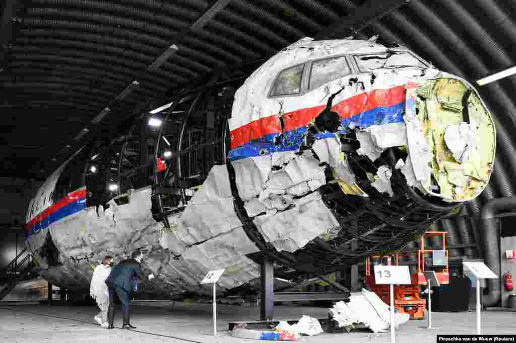 Avokatët analizojnë skeletin e rikrijuar të avionit të fluturimit MH17 të Malaysia Airlines, në bazën ajrore Gilze-Rijen, në Holandë, më 26 maj 2021.