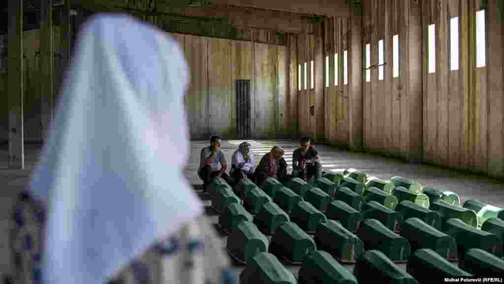 Coffins containing the remains of 71 people killed in Srebrenica are discharged from a former battery factory&nbsp;at the&nbsp;Potocari Memorial Center, on July 10, ahead of burial the next day.