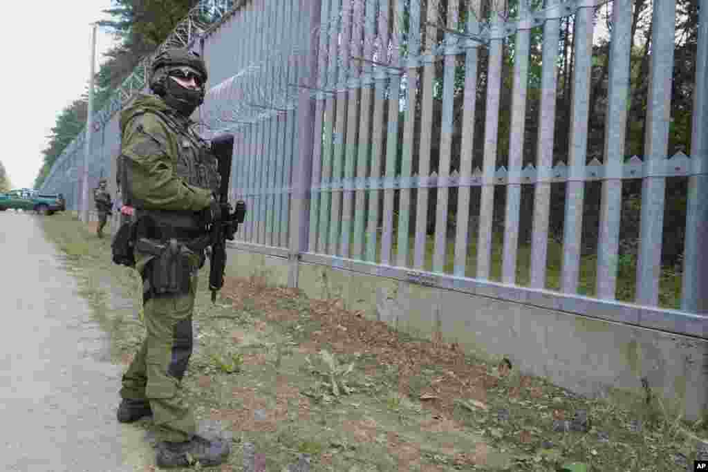 A Polish serviceman stands guard at the Poland-Belarus border in the village of Polowce.