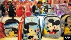 A vendor sells Mickey Mouse bags and other merchandise at a Disney flagship store in Shanghai, China.