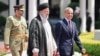 Iranian President Ebrahim Raisi (center) walks with Pakistani Prime Minister Shehbaz Sharif (right) to inspect a guard of honor in Islamabad on April 22.