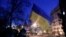 The Ukrainian national flag flies above an antigovernment barricade that faces a cordon of riot police in Kyiv on February 3.