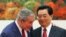 Chinese President Hu (right) with U.S. counterpart Bush in Beijing on August 8